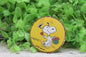Running White Dog with Flowers Circle Badge Reel